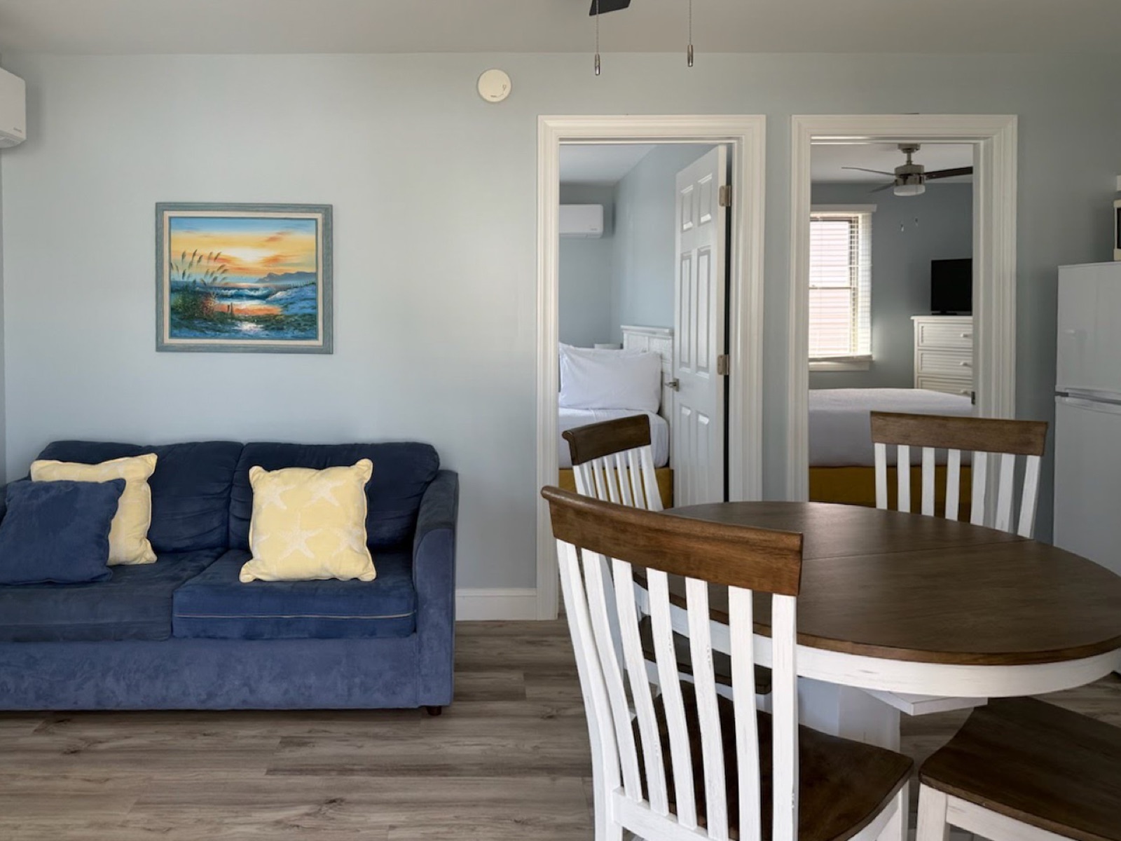 Living and dining area with both bedrooms beyond