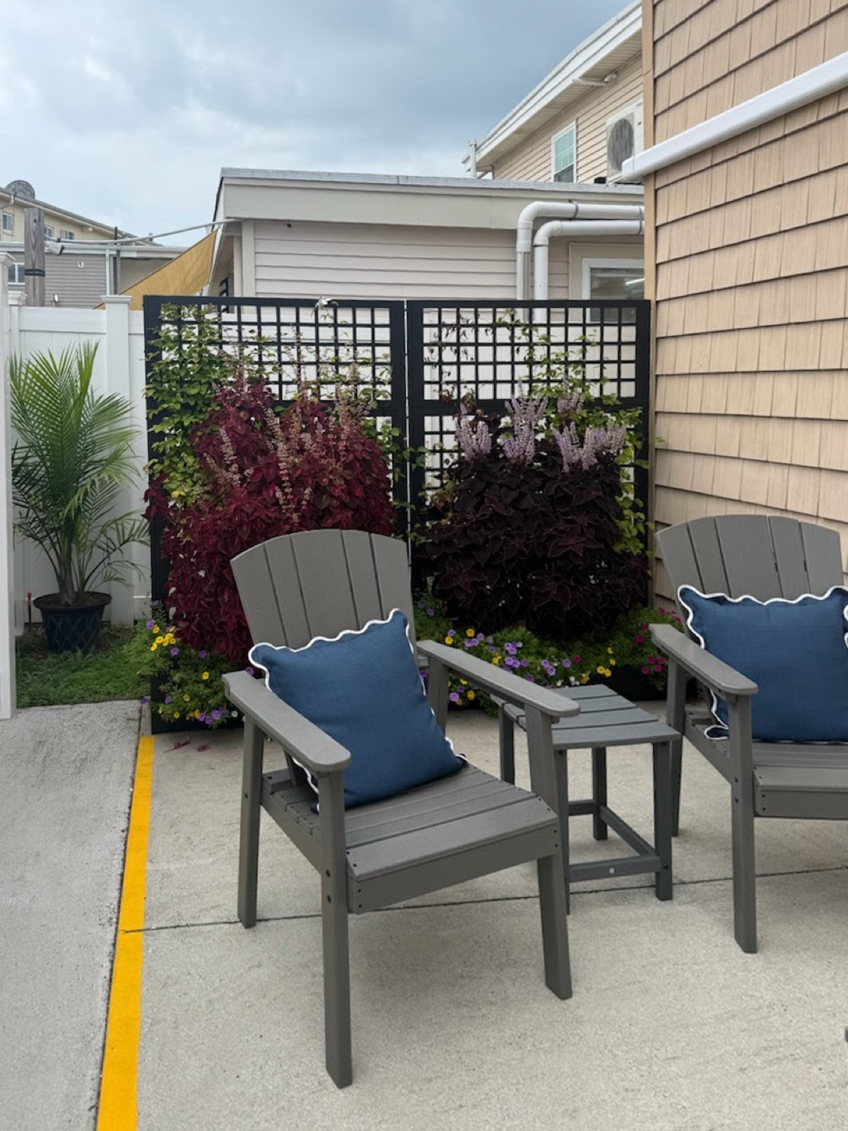 Patio chairs beside the flower wall