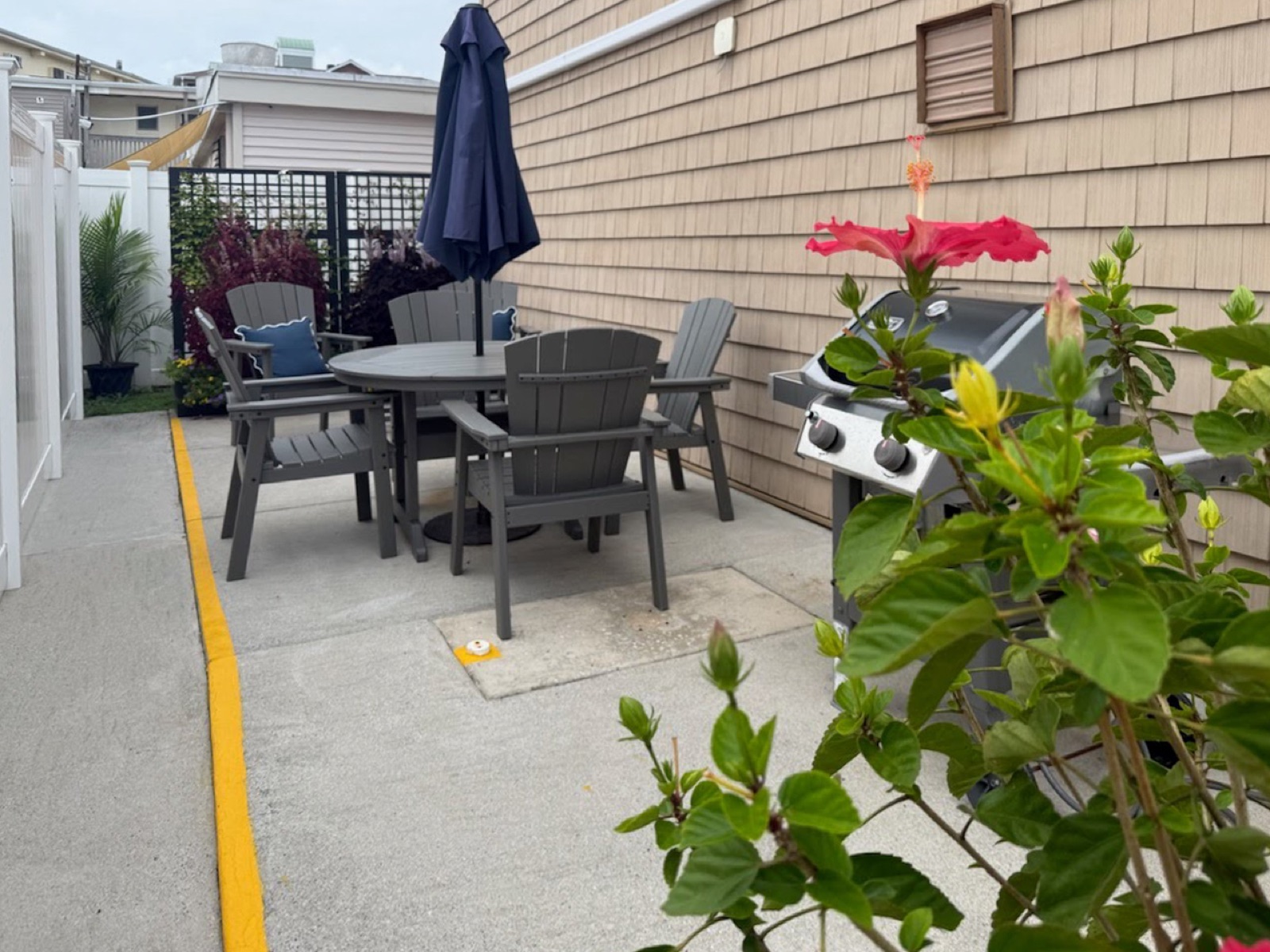 Patio with dining table and grill